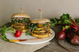 Double-stacked burger made with Alkeme gluten-free buns, fresh ingredients, and vibrant toppings